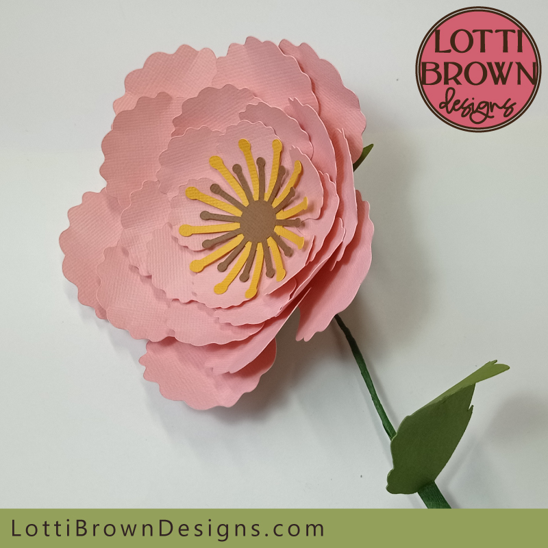 Pink paper flower with stem and leaf