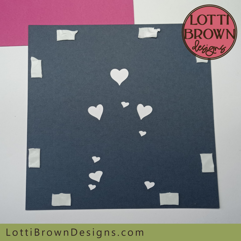 Positioning double-sided sticky tabs around the BACK of the hearts layer