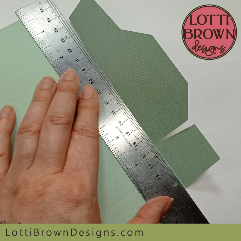 Fold the first flap against the metal rule