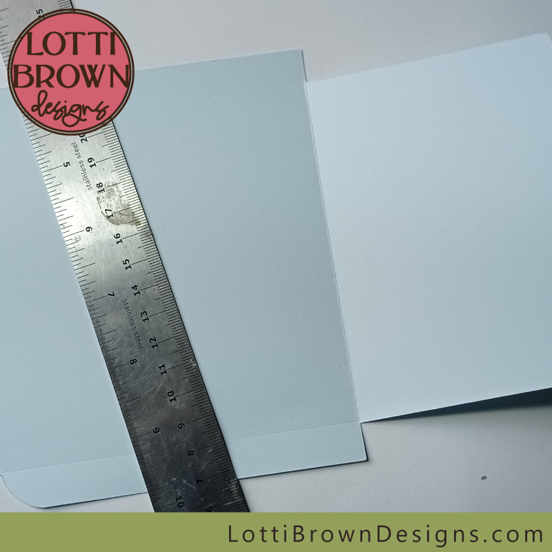 Use the metal ruler to create the folds for the envelope