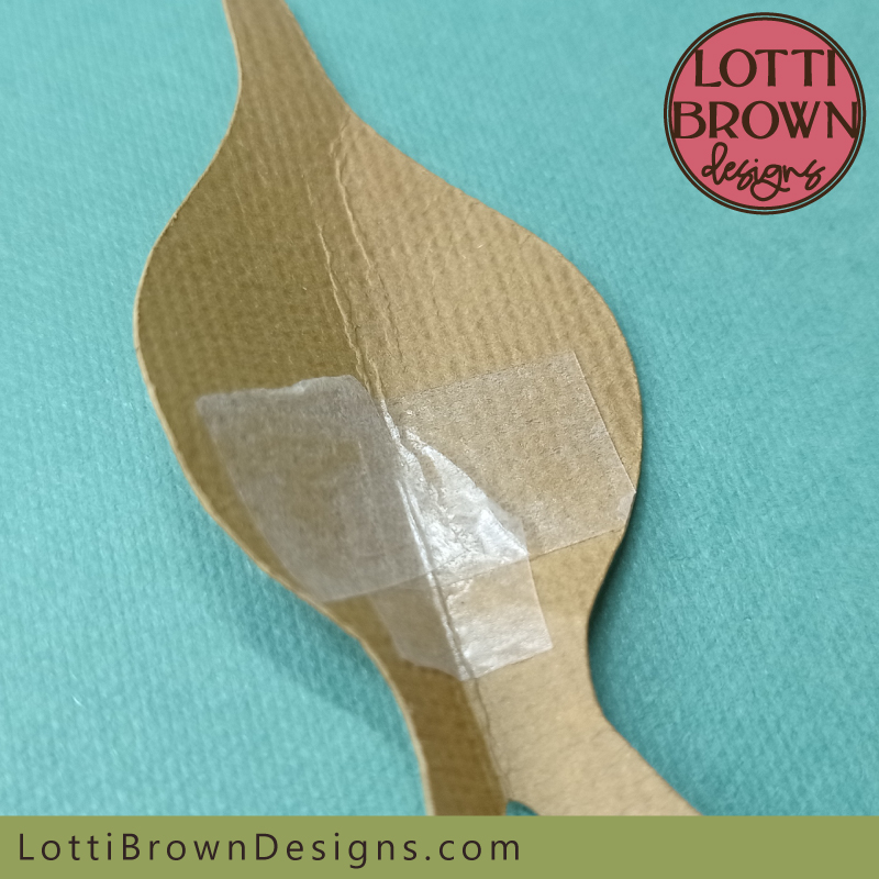 Add double-sided sticky tape to the inside of the shape