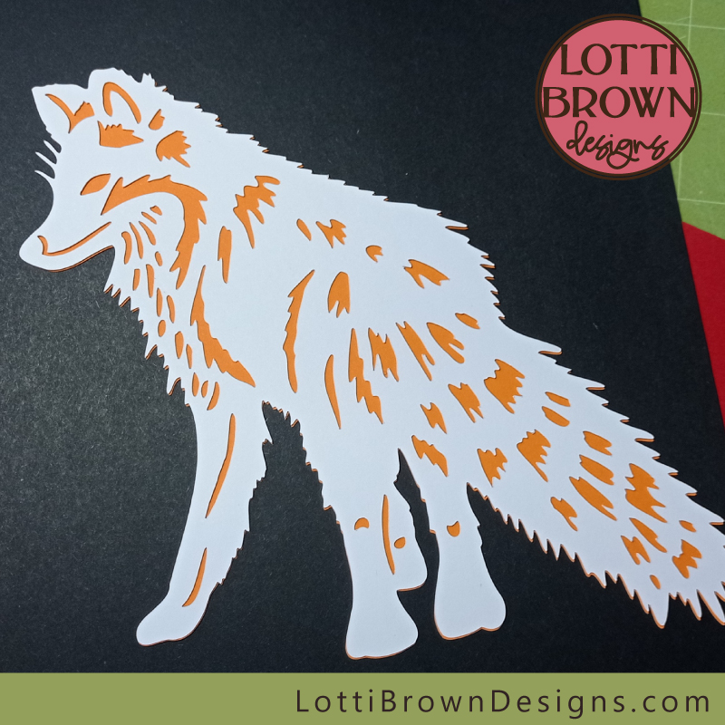 Papercut fox with smooth white card and generic craft card behind