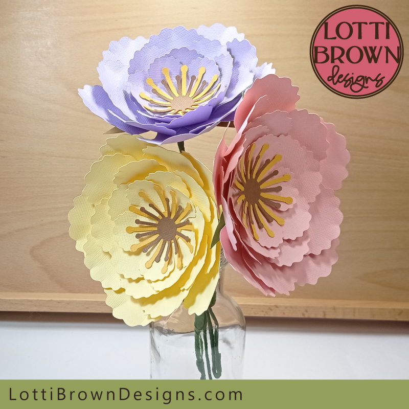 Pretty paper flowers with stems displayed in a vase