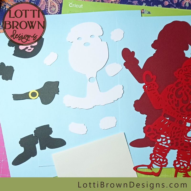 Gather the cut cardstock pieces of Santa together
