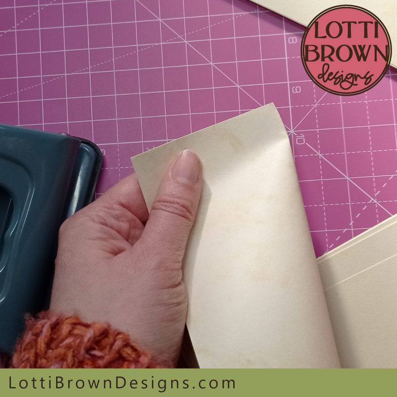 Fold a page length ways, creasing one end of the sheet only