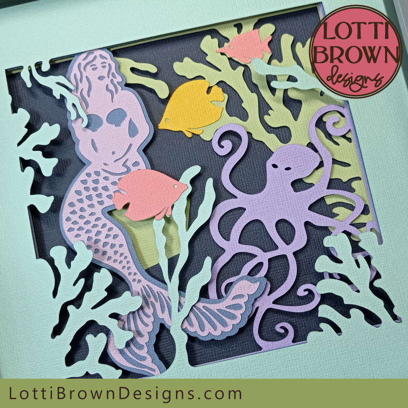 Colourful mermaid shadow box craft project in lilacs, pale greens, navy, pink and yellow